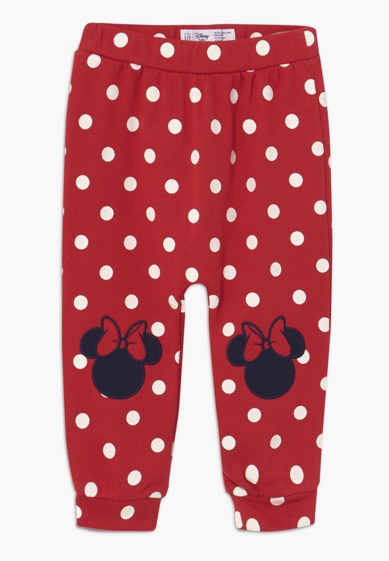 Pantalon rouge pour tout-petit avec des pois blancs et des têtes de Minnie Mouse noires avec des nœuds rouges sur les genoux.