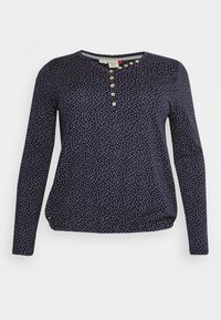 Marinblå långärmad skjorta med vita prickar, rund halsringning och knapplist med fem träknappar, rynkor vid nederkant.