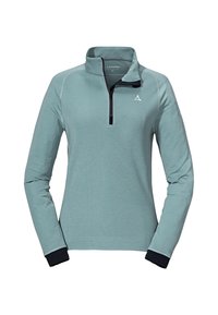 Světle modrý pulovr s čtvrtinovým zipem, dlouhými rukávy a námořnickými manžetami. Obsahuje kontrastní švy a logo na prsou.