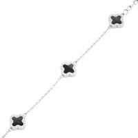 Silver chain bracelet featuring four black stone flower-shaped accents, alternating with smooth silver links and textured detailing.