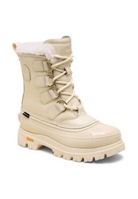 Beige vedenkestävä saapas, jossa on tekokarvavuori, metalliset hakaset ja paksu kumipohja. Sileä pinta, jossa on kohokuvioita ja Vibram-logo.