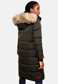 Green padded parka coat with a faux fur-trimmed hood, long length, quilted design, and two side pockets. Leather logo accent near hem.