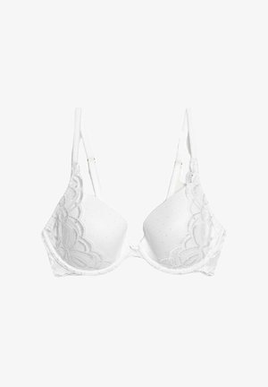 Witte gevoerde bh met kanten trim, stippenstructuur, verstelbare bandjes en een decoratieve strik in het midden. Ontworpen voor comfort en ondersteuning.