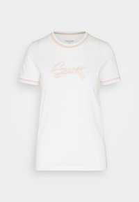 Vit kortärmad t-shirt med ljusrosa kant på krage och ärmar, med upphöjd ljusrosa "Guess"-logotyp på framsidan.
