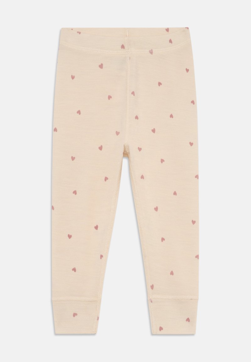 Leggings beige clair avec une texture douce, ornés de petits cœurs roses et d'une taille élastique. Design fuselé avec des poignets ajustés aux chevilles.