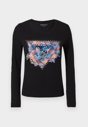 Schwarzes langärmliges T-Shirt mit einem dreieckigen Blumenmotiv und dem Text "GUESS?", verziert mit Strasssteinen, in der Mitte der Brust.