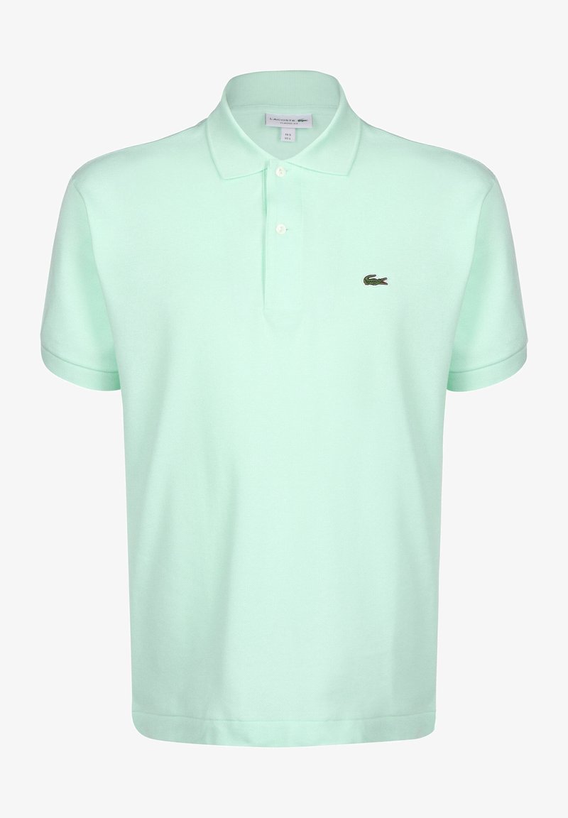 Polo en vert menthe clair, fabriqué en coton doux, avec un col boutonné, trois boutons et un petit logo brodé sur la poitrine.