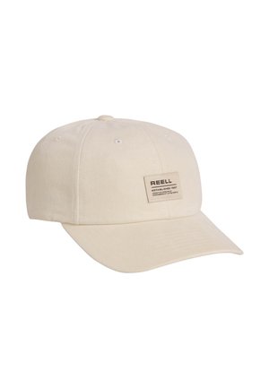 Beige cotton baseball cap with sewn rectangular patch reading "REELL" and text on front panel, curved brim, and ventilation holes on top.