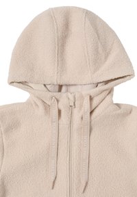 Veste à capuche zippée en polaire beige clair avec un extérieur texturé, une capuche doublée et des cordons de serrage contrastants présentant un motif en relief.