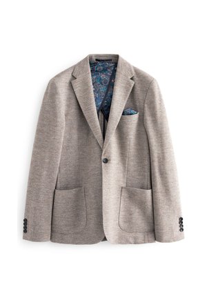 Jasnobrązowa marynarka w wzór houndstooth, z dwoma przednimi kieszeniami i wzorzystym niebieskim wnętrzem. Posiada czarne guziki na rękawach i kieszeni piersiowej.