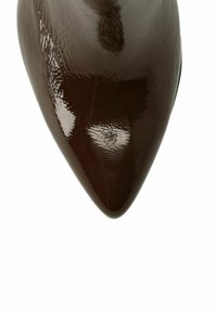 Glossy brown patent leather pointed toe pump, featuring a sleek design and smooth texture, emphasizing its shiny surface and elegant shape.