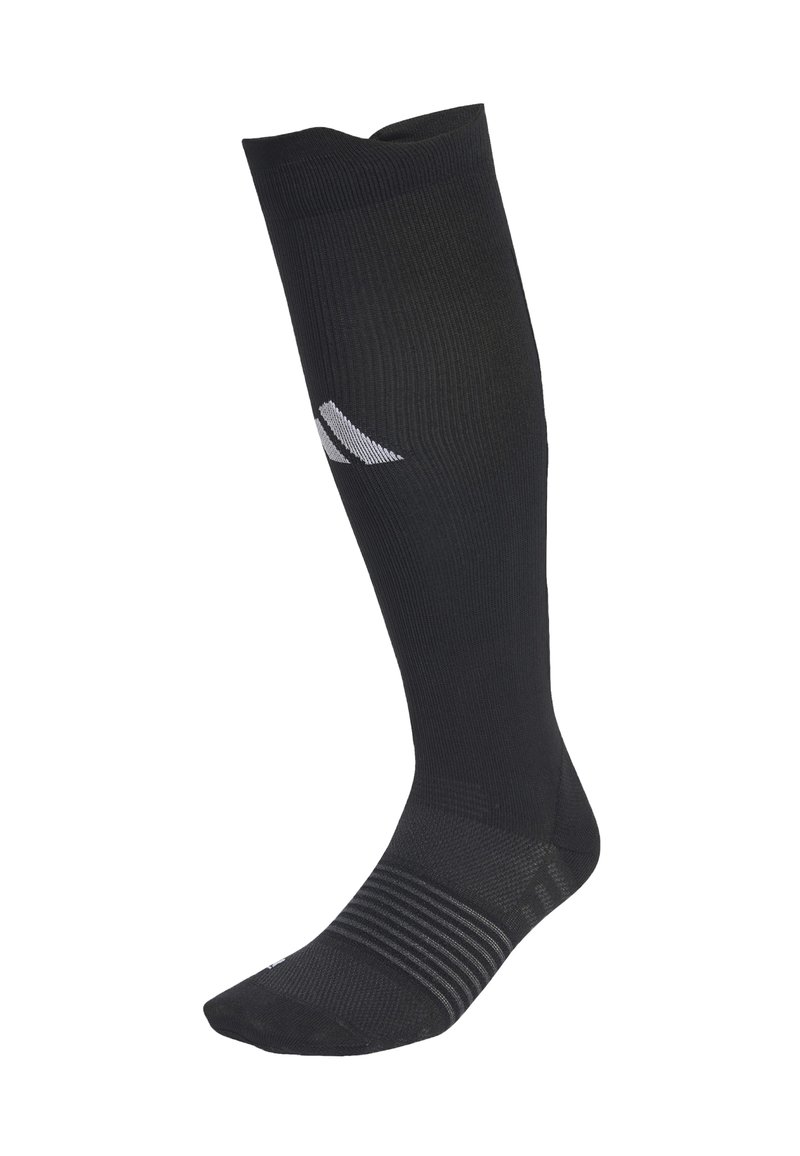 Mustat polven ylle ulottuvat kompressiosukat, joissa on uritetut kuviot ja pieni valkoinen logo pohkeessa.