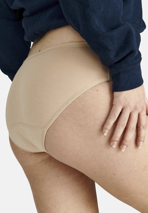 Beige cotton underwear with a smooth texture, featuring a low-rise design and delicate stitching along the waistband and leg openings.