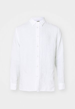 Biała koszula z długim rękawem wykonana z lnu. Posiada pełne zapięcie na guziki, kołnierzyk oraz mankiety. Gładka tekstura o lekkim, przewiewnym wyglądzie.