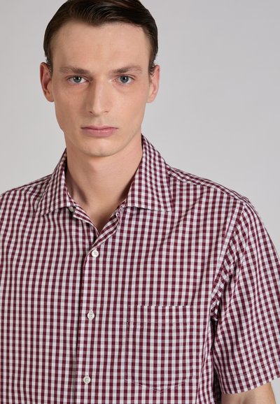 Chemise à manches courtes à carreaux avec un motif vichy bordeaux et blanc, boutons sur le devant, et une poche sur la poitrine gauche. Confectionnée dans un tissu à la texture lisse.