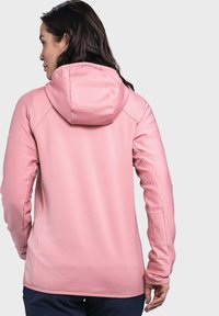 Giacca rosa con cappuccio, superficie texturizzata, design aderente e maniche lunghe. Presenta un cappuccio arricciato e un profilo posteriore rilassato.