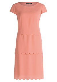 Pfirsichfarbenes Kleid aus glattem Stoff, mit kurzen Ärmeln, einem runden Ausschnitt und einem gewellten Saumdesign. Schlichte, gerade Silhouette.