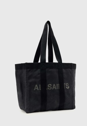 Μαύρη καμβά τσάντα AllSaints με δύο μακριές λαβές και διακριτικό λογότυπο στο μπροστινό μέρος, σε μονόχρωμο φόντο.