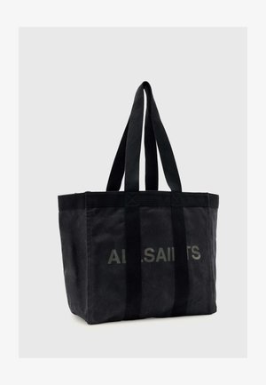 Μαύρη καμβά τσάντα AllSaints με δύο μακριές λαβές και διακριτικό λογότυπο στο μπροστινό μέρος, σε μονόχρωμο φόντο.