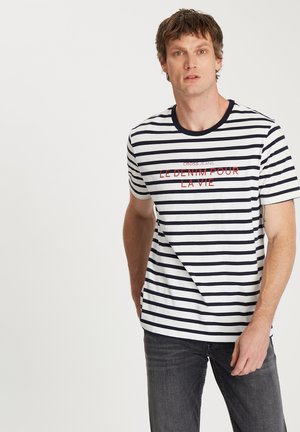 Pasiasty t-shirt z krótkim rękawem w kolorze granatowym i białym. Posiada okrągły dekolt oraz nadruk tekstowy na czerwono z napisem "LE DENIM POUR LA VIE."