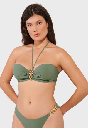 Olive green bikini set with a strapless top featuring a twisted design and gold leaf accents at the center and hip. Smooth texture.