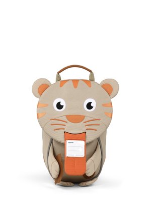 Children's backpack shaped like a beige and orange tiger with eyes, ears, whiskers, and a handle on top, featuring a name tag on the front flap.