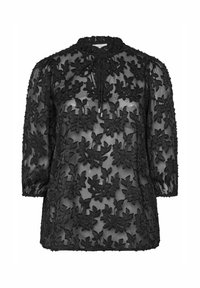 Blouse noire transparente avec un broderie florale noire complexe, des manches trois-quarts et un détail de col à nouer, créant une apparence texturée.