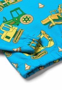 Tela azul con patrones de vehículos de construcción en amarillo y verde, incluyendo tractores y excavadoras, con conos de tráfico naranjas mostrados de manera prominente.