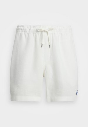 Calções brancos de linho com um cós elástico e cordão, apresentando um pequeno logo azul marinho no lado esquerdo. Textura suave, design casual.