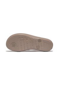 Tan rubber schoenzool met een getextureerd oppervlak, voorzien van cirkelvormige grippatronen en een geperst merklogo. Twee cirkelvormige accenten nabij de hiel.