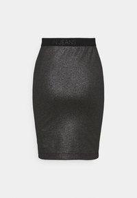 Black sparkly pencil skirt made from stretchy fabric. Features a wide, branded waistband with "CALVIN JEANS" in a subtle pattern.