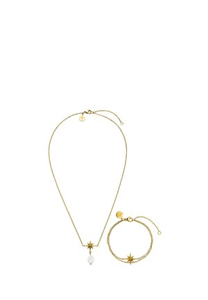 Delicate gold necklace with star and pearl pendant, paired with matching gold chain bracelet featuring a star charm and adjustable clasps.