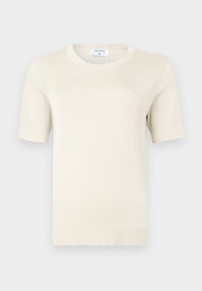 Pull en maille crème, doux, à manches courtes avec un col rond. Comprend un ourlet et des poignets côtelés, fabriqué en matériau léger.