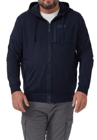 Marineblauwe zip-up hoodie met een voorzak, een capuchon met trekkoord en geribde boorden. Gemaakt van zachte stof met een gladde textuur en heeft subtiele stikseldetails.