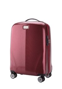 Valigia rigida di colore bordeaux profondo, superficie testurizzata, ruote nere e maniglia. Presenta una chiusura con zip e una piastra con il marchio sul davanti.