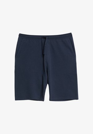 Ciemnoniebieskie teksturowane szorty z przednimi kieszeniami i sznurkiem w pasie, ułożone płasko na białym tle.