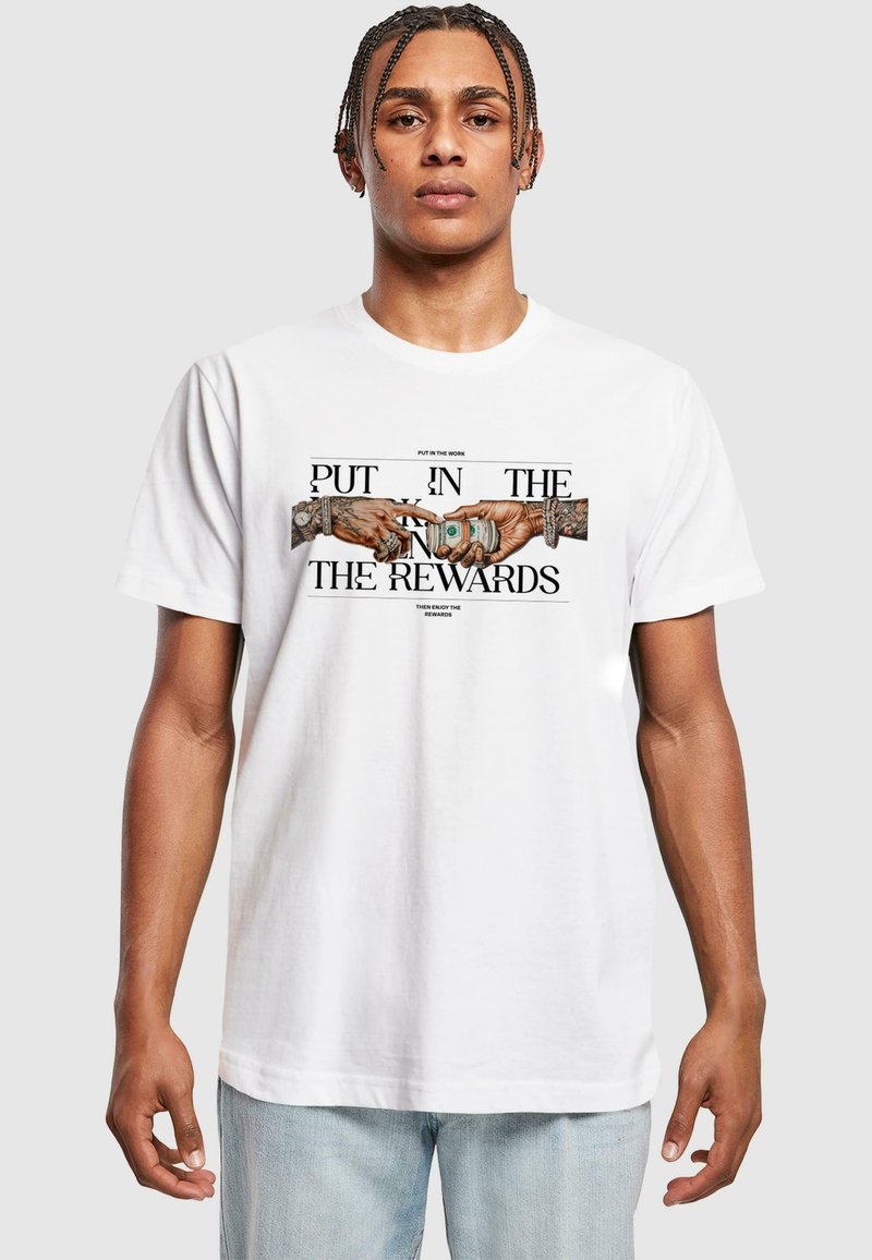 White cotton t-shirt featuring a graphic of two hands exchanging money, with black text above and below reading "PUT IN THE WORK" and "ENJOY THE REWARDS."