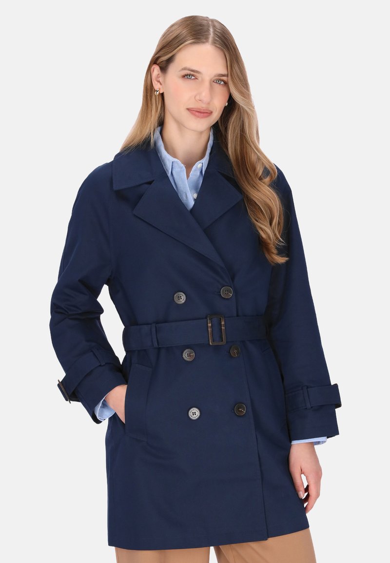 Trenci albastru marin cu design cu două rânduri de nasturi, curea și accesorii cu nasturi. Dispune de guler și buzunare laterale.