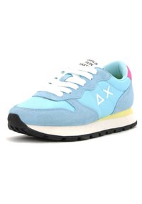 Light blue sneaker with white laces, black sole, pink heel accent, "ΔX" logo on side, and "GIRLS RUN FAST" text on tongue.