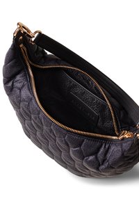 Quilted black leather handbag with a zip closure and a smooth black strap. Interior reveals a textured lining and a brand label.