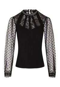 Sort top med en blonde yoke og polka dot gennemsigtige ærmer. Ærmerne har en scalloped kant, der tilføjer tekstur og et dekorativt element.