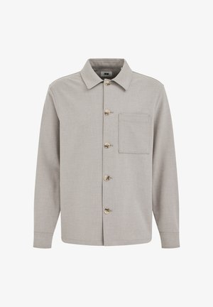 Gaiši pelēka, garām piedurknēm jaka ar apkakli, pieciem pogām priekšpusē un vienu krūšu kabatu kreisajā pusē.