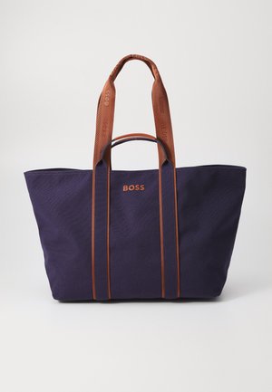 Navy canvas tote bag with brown handles, featuring embossed "BOSS" logo. Spacious design with reinforced stitching and contrast accents.