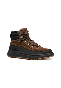 Botas de senderismo de ante marrón y tela negra con cordones planos, ojales de metal y una suela de goma texturizada para tracción y durabilidad.