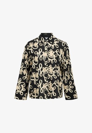 Chemise noire à manches longues avec des boutons, ornée de motifs floraux et de boucles brodés beiges sur toute la surface.