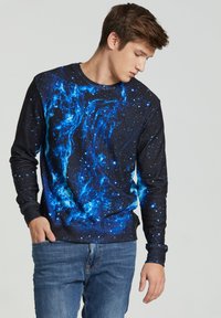 Long-sleeve sweatshirt featuring a black base with a vivid blue galaxy print. Made of soft fabric, it has ribbed cuffs and a crew neckline.