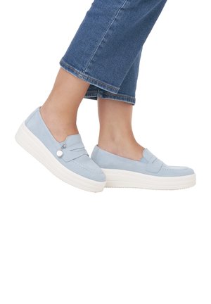 Light blue slip-on shoes made of suede with a textured finish, featuring a thick white sole and a decorative strap across the front.