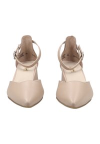 Pointed-toe low-heel shoes in beige leather with ankle strap and buckle detail. Smooth texture, minimalist design, and flat sole.