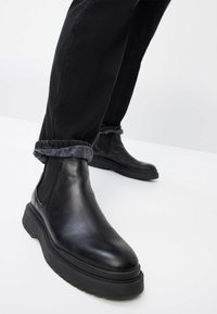 BRAX STYLE CHUCK TT - Straight leg jeans - black used