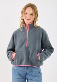 Gray fleece pullover with a quarter-zip and pink accents, featuring a front pocket and contrast trim at the cuffs and hem.